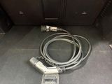 a cable connected to a cell phone in the back of a vehicle