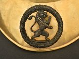 a gold plate with a lion on it on a table