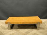 a wooden coffee table sitting on top of a wooden floor