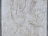 a stone plaque with a drawing of a ship on it