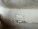 the inside of a chanel bag with the handle open