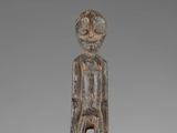 an image of a wooden statue of a man with a hat on his head