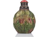 a small glass bottle with a red cap on it