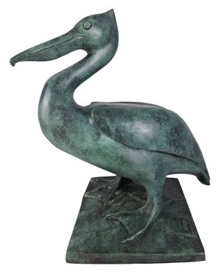 statue of a pelican standing on a base on a white background