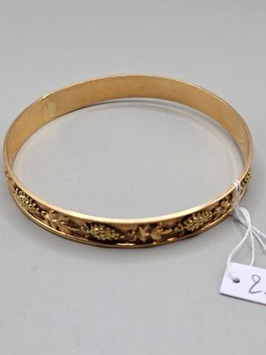 a close up of a gold bracelet with a price tag on it