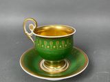 green and gold tea cup and saucer
