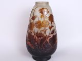 a vase with a flower design on it on a table