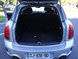 the back of a silver car with its trunk open on the road