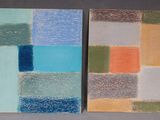 two paintings of different colors are on a gray surface