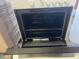 a white oven with the door open on a counter