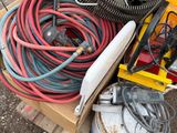 a pile of hoses and other electrical equipment on a pallet