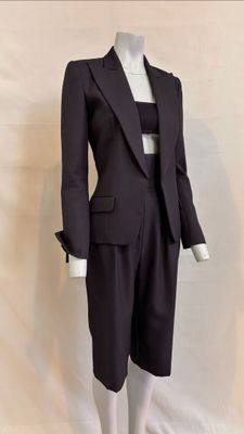 a mannequin wearing a suit and tie on a mannequin stand