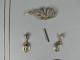 a lot of jewelry that is laying out on the table