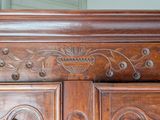 a close up of a wooden cabinet with carvings on it