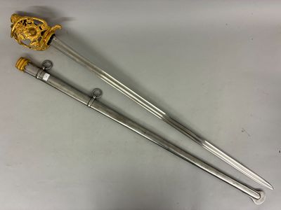 two swords with gold handles and a gold crown on top