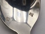 a silver spoon with a picture of a cat on it