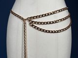 a white mannequin torso with a chain belt on it