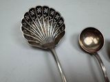two spoons that are sitting next to each other on a table