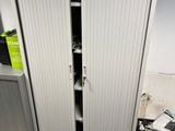 a metal cabinet with a door open in a room