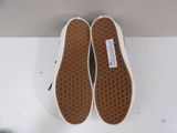 vans slip - ons with white soles on a white surface