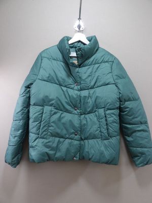 the jacket is hanging on a hanger on the wall