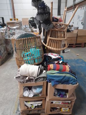 a pile of clothes on a cart in a warehouse
