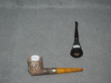 a pipe and a pipe holder sitting on the floor