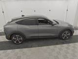 a gray car is parked in a garage with a checkered floor