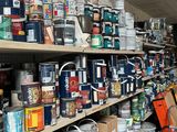 many cans of paint on the shelves in the room