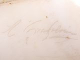 a white vase with writing on it sitting on a table