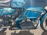 a blue motorcycle that is parked in the parking lot