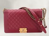 a chanel red quilted leather shoulder bag with gold hardware