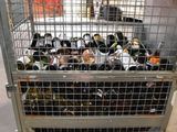 a metal cage filled with bottles of wine on the floor