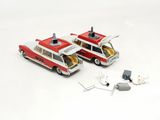 two red and white firetrucks sitting next to each other on a white surface