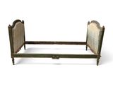 a bed that has a wooden frame and headboard on it