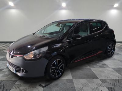 a black car is parked on a checkered floor in a garage