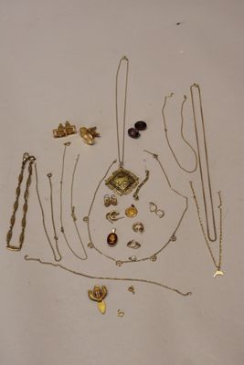 a lot of gold necklaces and bracelets laid out on a table