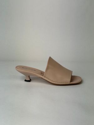 an image of a pair of nude colored shoes on a white background
