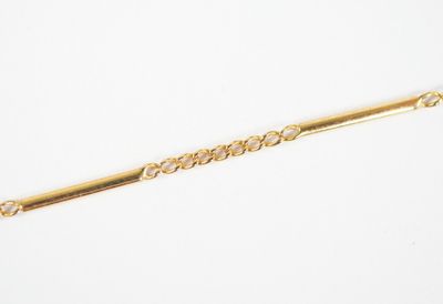 a close up of a gold bracelet with a chain on it