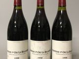 trois bouteilles de vin rouge posées sur une table l'une à côté de l'autre