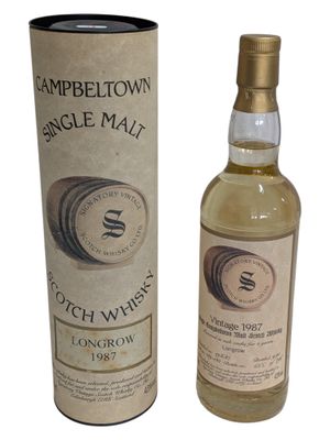 a bottle of scotch whisky next to a cardboard box