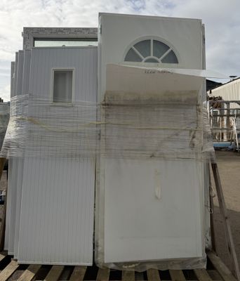 a stack of white refrigerators sitting on a pallet