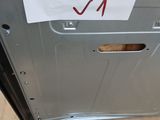 a sign on the door of a silver refrigerator