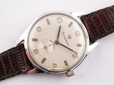 a close up of a wrist watch with a brown leather strap
