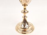 a silver chalicet on a stand on a white background