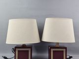 pair of red and gold table lamps with white lampshads