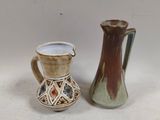 two vases sitting next to each other on a table