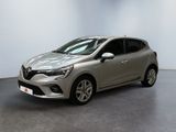 a silver car is parked in a room with a white wall