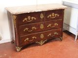 a small chest of drawers with a marble top