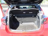 the back of a red car with its trunk open in a parking lot